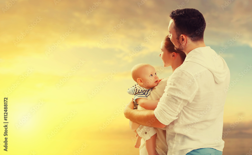 happy family mother, father and baby on sea