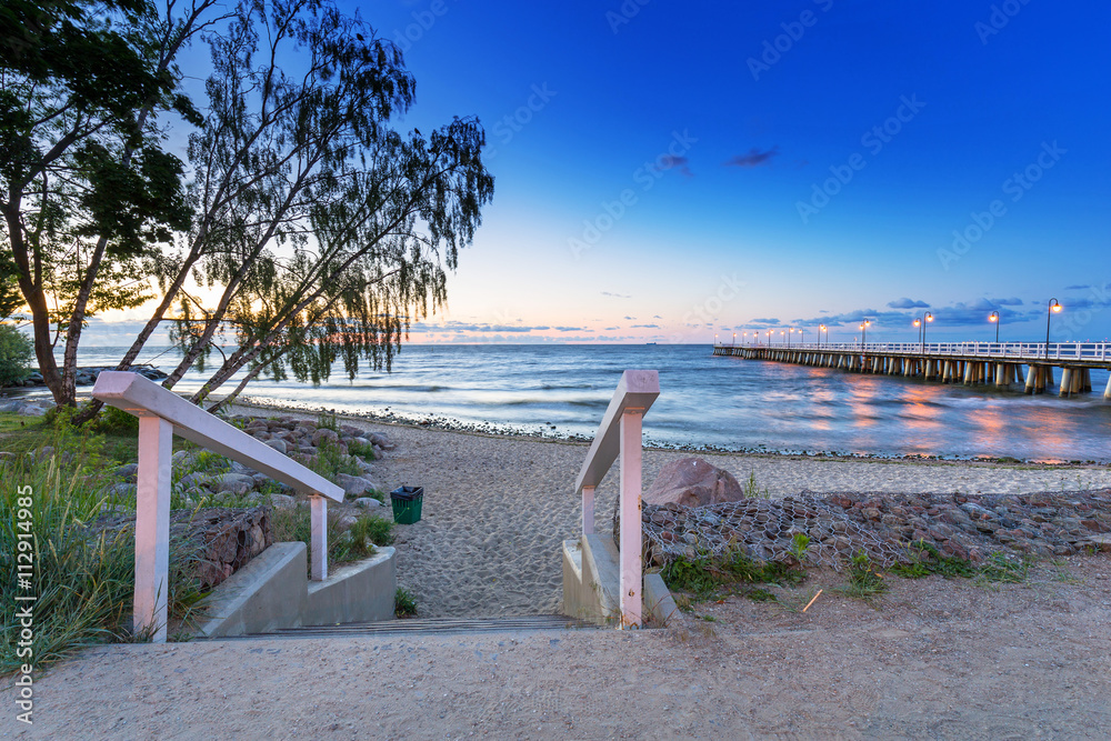 Baltic sea with pier in Gdynia Orlowo at sunrise, Poland