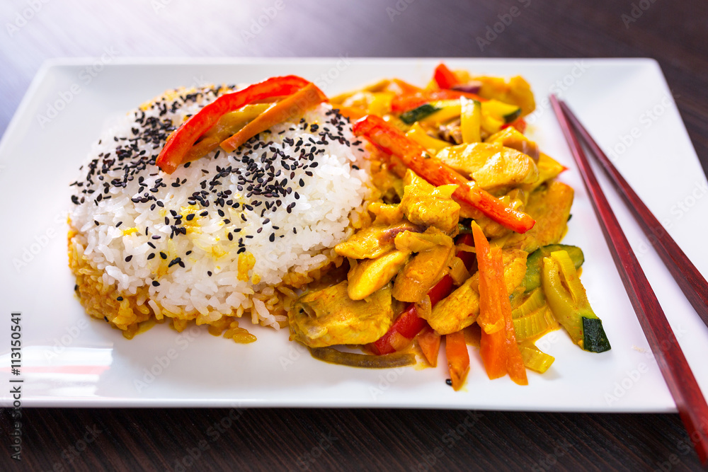 Thai dish with chicken in green curry souce and rice