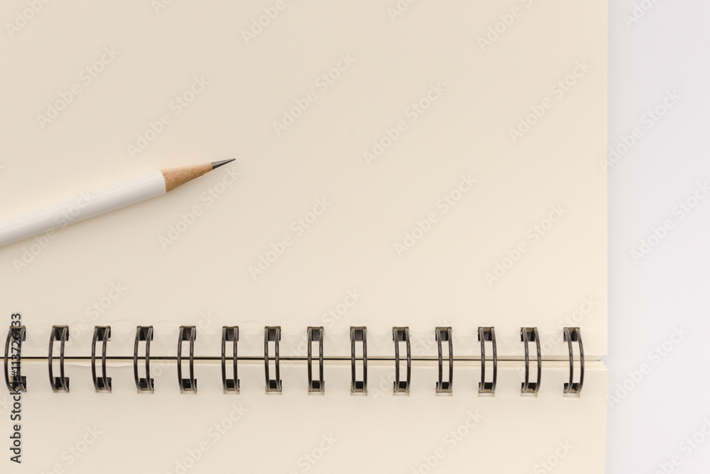 white pencil with blank notebook on white