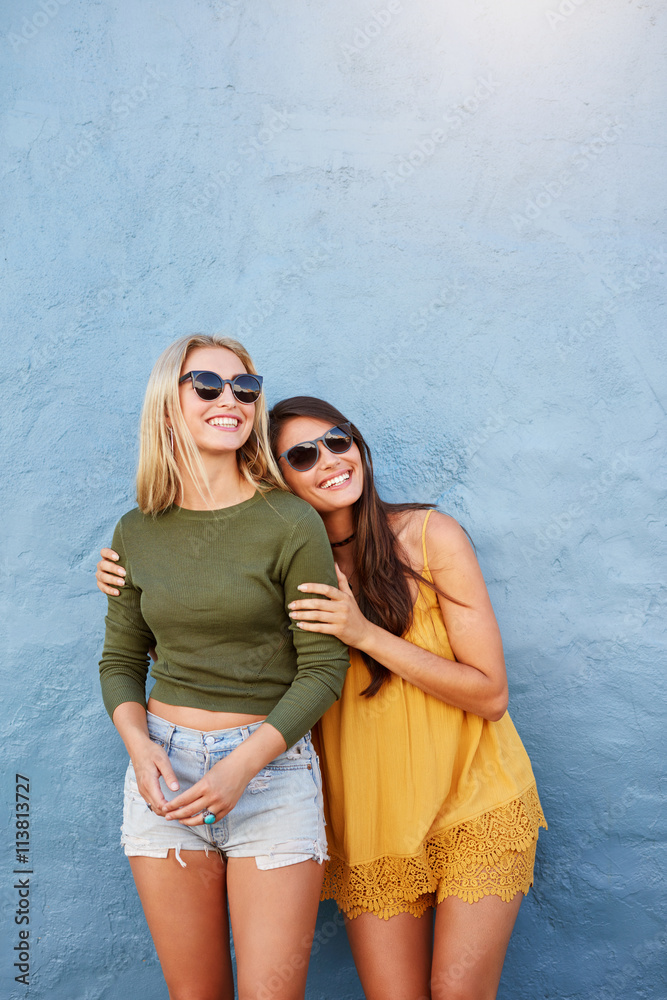 Stylish female models looking away and smiling