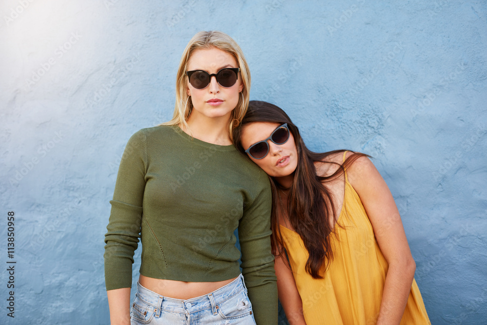 Stylish young female models on blue background