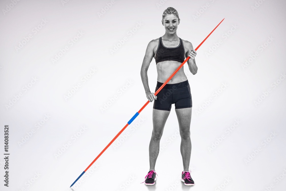 Composite image of athlete standing with javelin