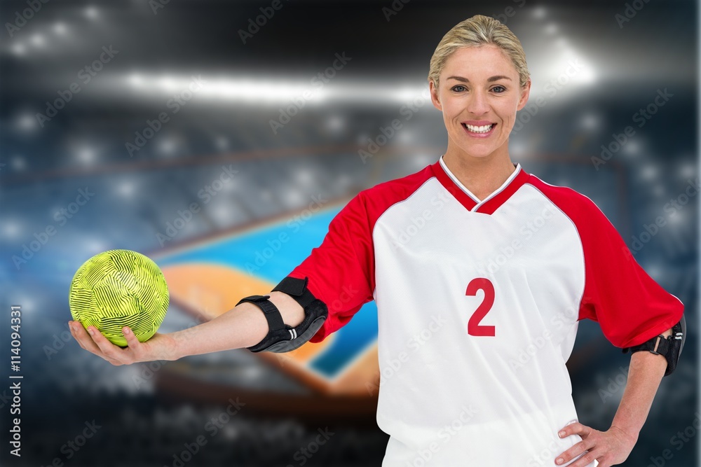 Composite image of sportswoman holding a ball