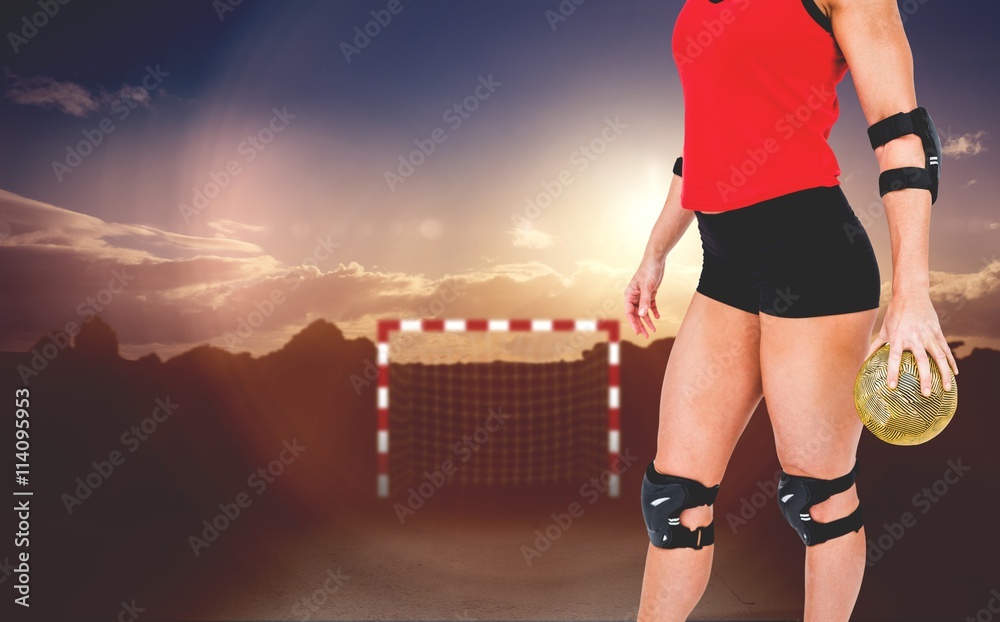 Female athlete with elbow pad holding handball 