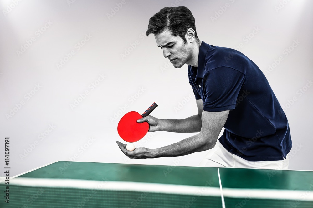 Composite image of confident male athlete playing table tennis