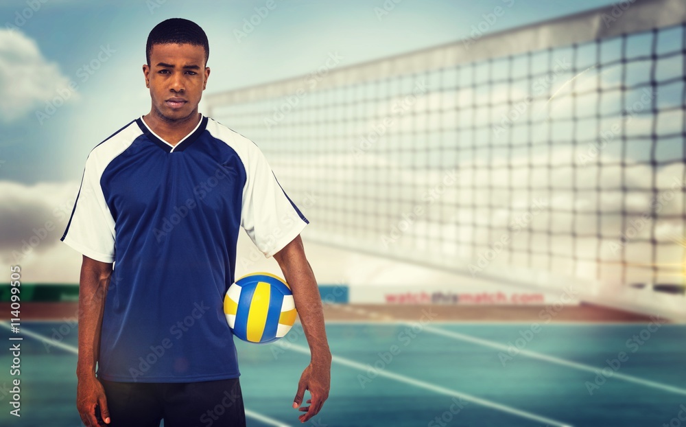 Composite image of sportsman holding a volleyball