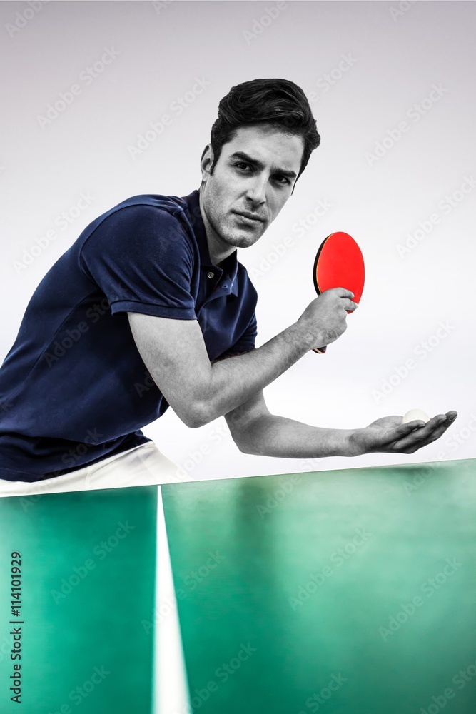 Composite image of confident male athlete playing table tennis