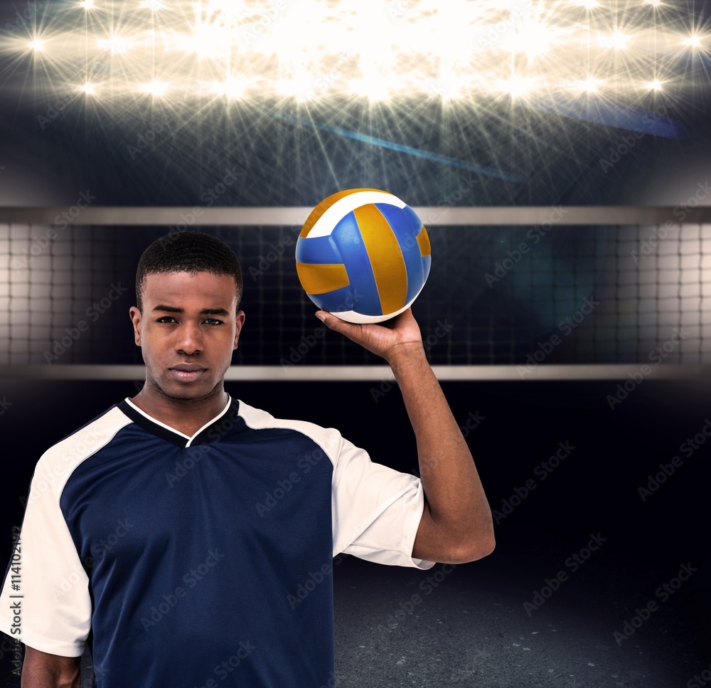 Composite image of sportsman holding a volleyball