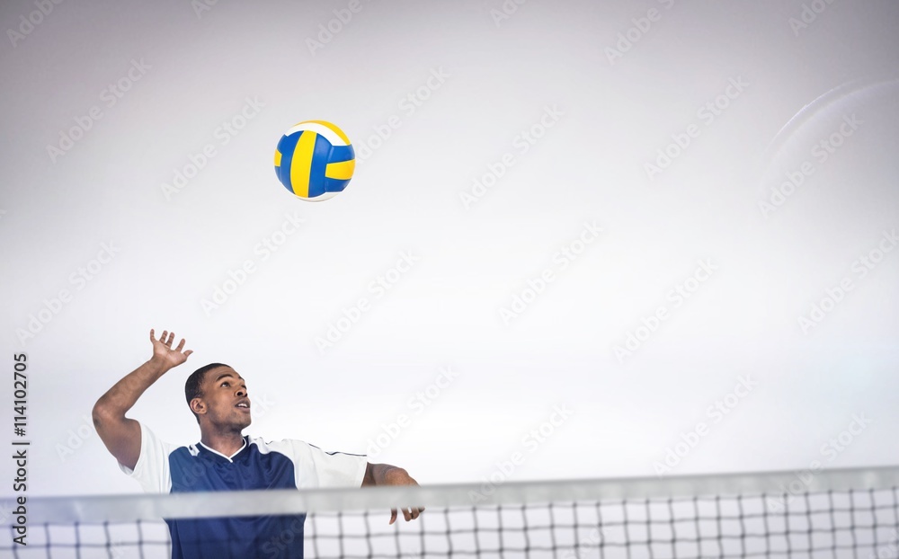 Composite image of sportsman posing while playing volleyball