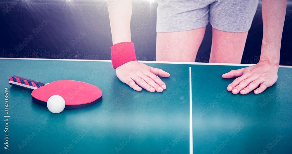 Composite image of female athlete leaning on ping pong table 