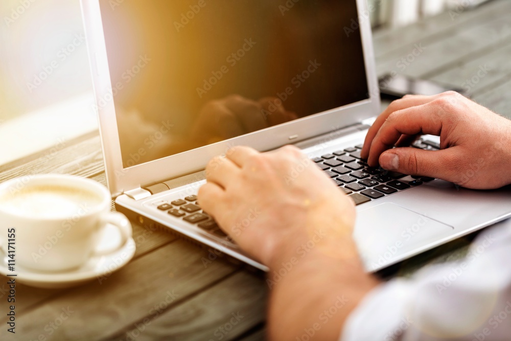 Business man hand working on laptop computer.