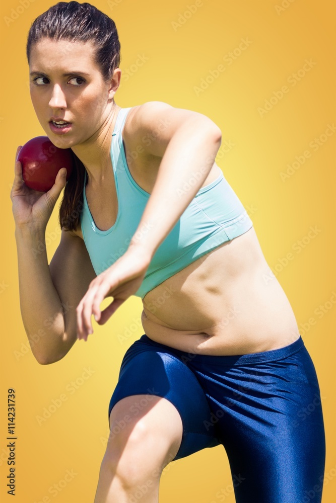 Composite image of sportswoman practising the shot put