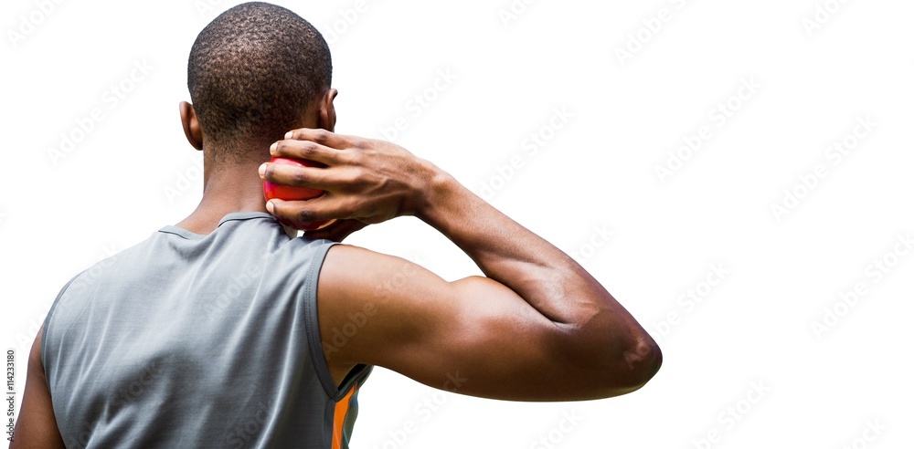 Rear view of sportsman practising shot put 