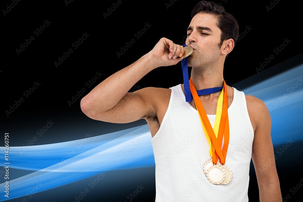 Composite image of happy athlete kissing medal