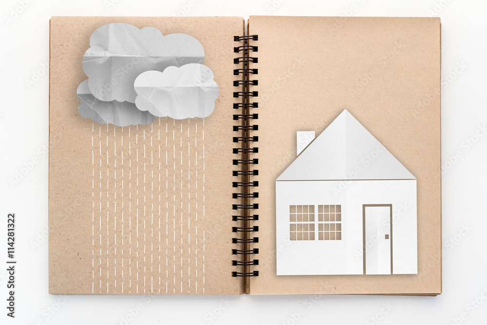 open sketch book with cloud with rain and house paper cut techni