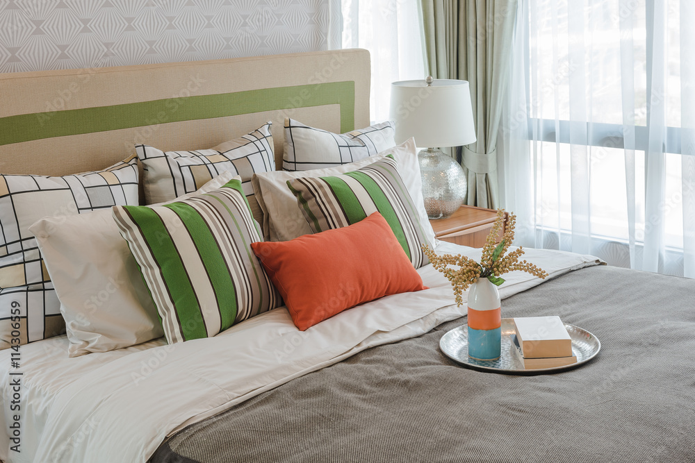 colorful pillows on white bed in modern bedroom design