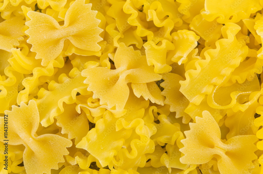 Uncooked bow tie farfalle pasta background