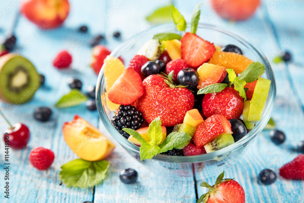 Fresh fruit salad served on wooden table