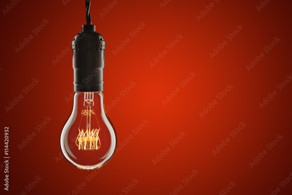 Vintage incandescent Edison type bulb on wooden background