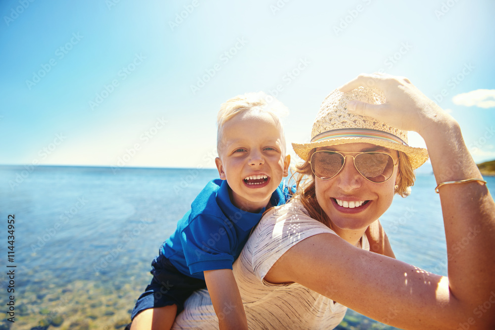 Happy young mother and son on a tropical beach