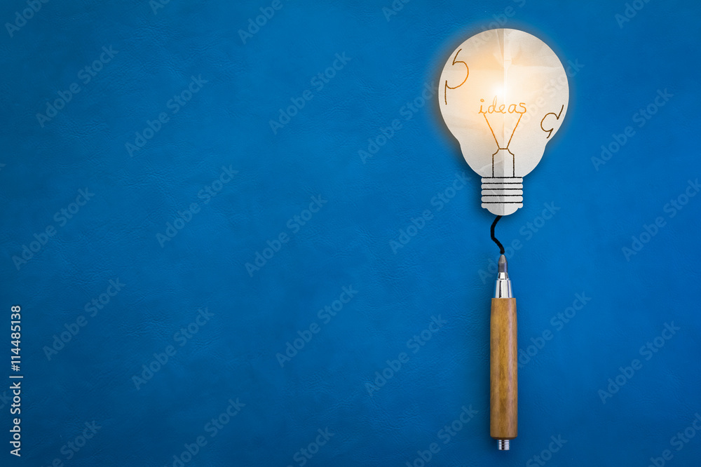 bulb paper and wooden pencil on blue background creativity ideas