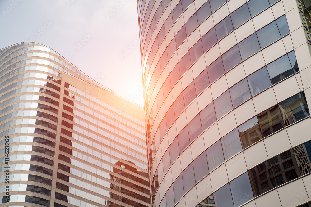 Clouds reflected in windows of modern business office building.