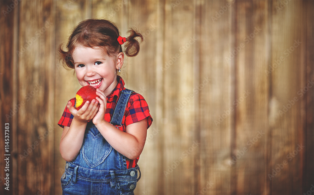 happy baby girl eats ripe peach