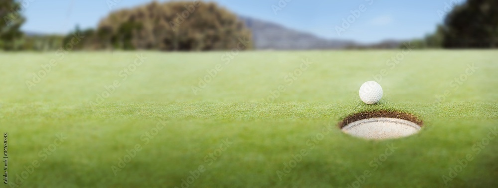 Golf ball at the edge of the hole