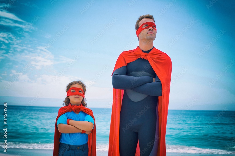 Confident man and son standing at sea shore