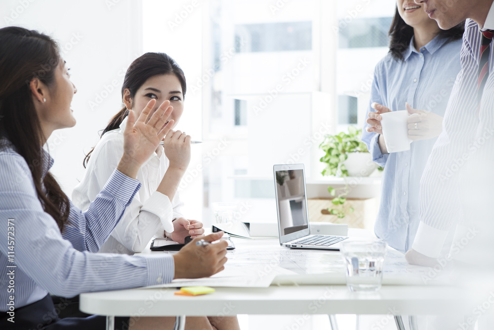 Business people are talking with a laugh during a break