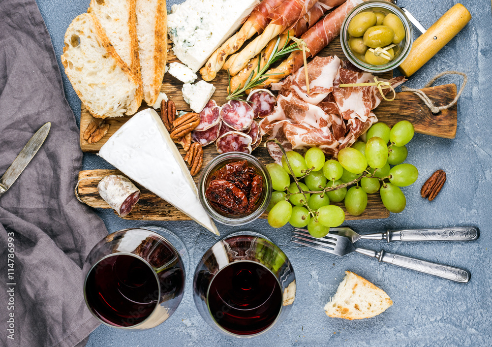 Cheese and meat appetizer selection. Prosciutto di Parma, salami, bread sticks, baguette slices, oli