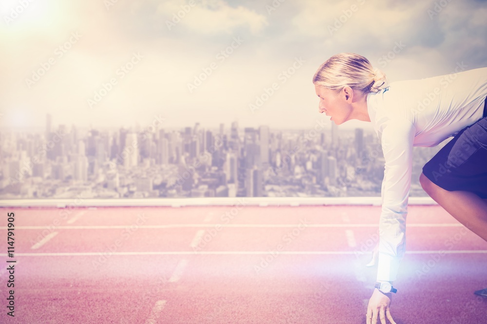 Composite image of businesswoman in the starting blocks