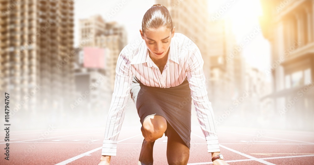 Composite image of businesswoman in the starting blocks 