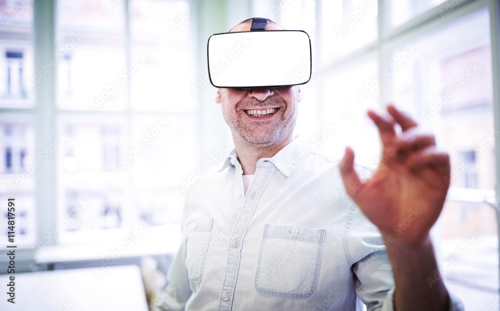 Smiling graphic designer using virtual reality headset 