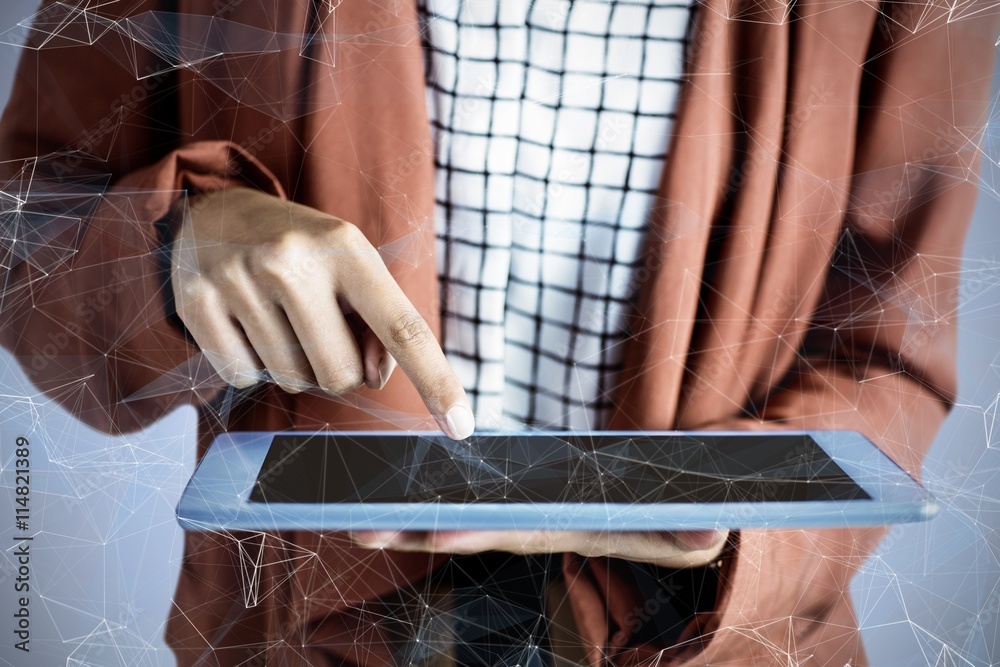 Composite image of businesswoman using a tablet