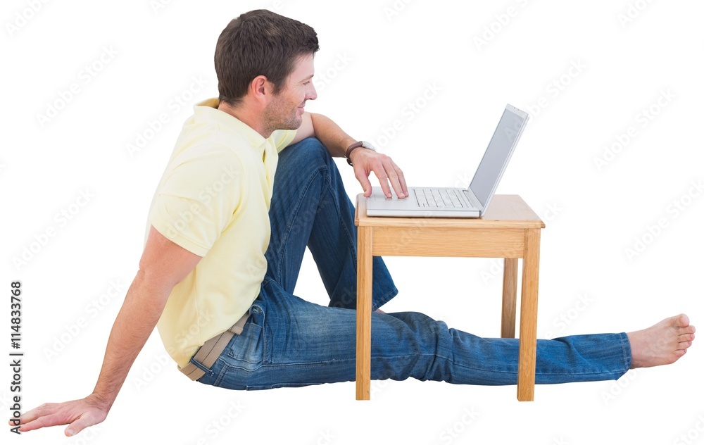 Smiling man using a laptop