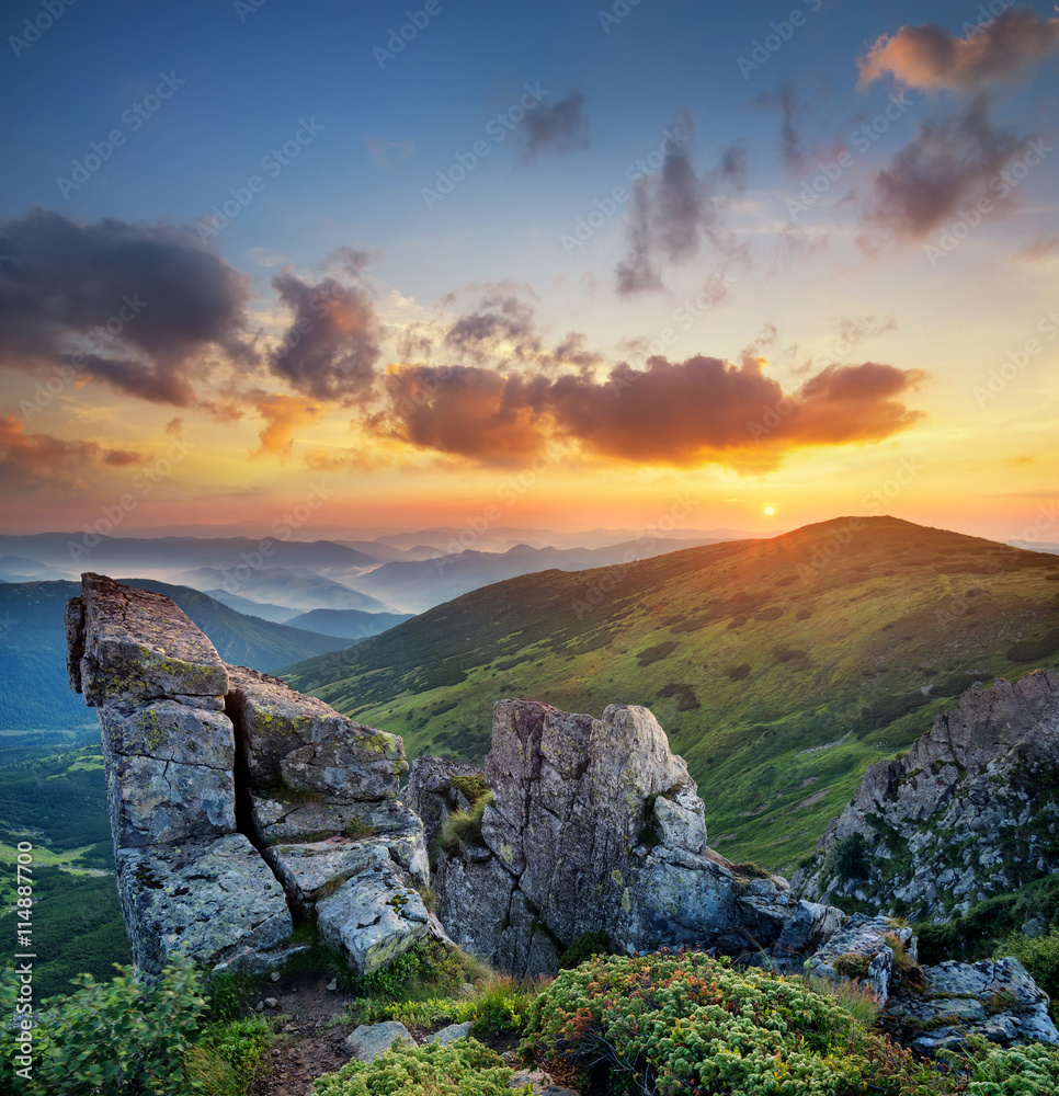 High rocks in mountain valley during sunrise. Natural summer landscape