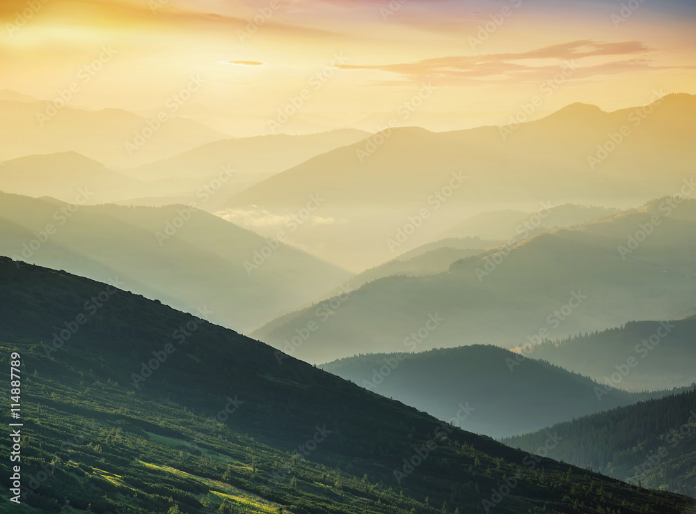 Hills during sunrise in mountain valley. Beautisul natural landscape