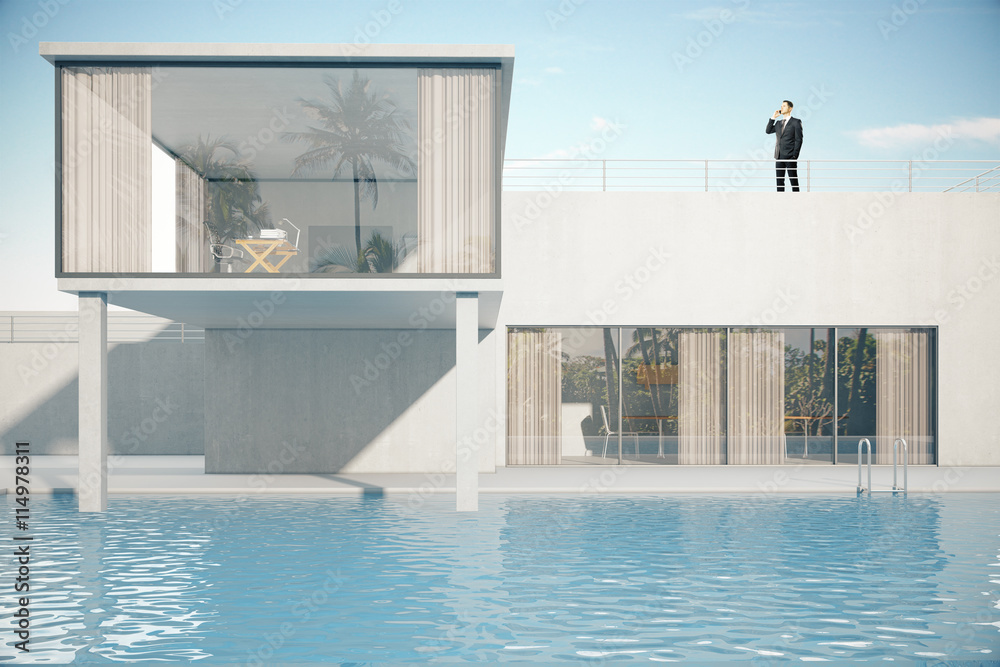 Businessman on roof of house