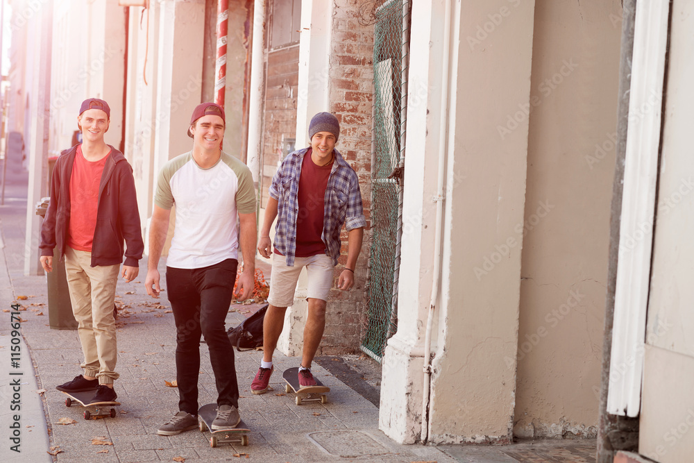 Guys skateboarders in street