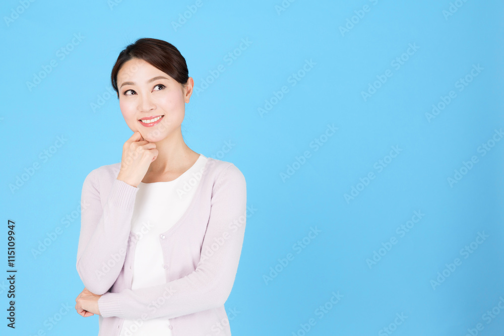 portrait of asian nurse isolated on blue background