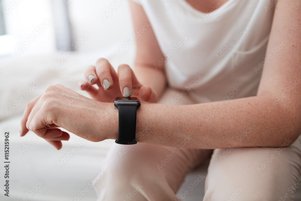 Woman using smartwatch to check time