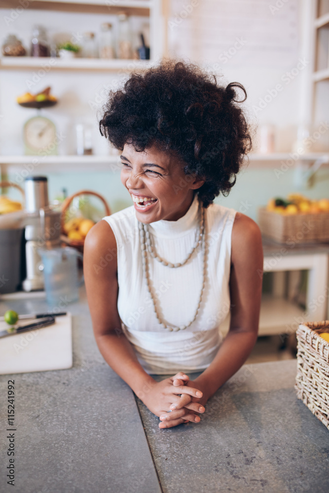 Successful juice bar owner looking away and smiling