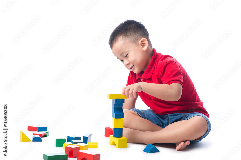 Asian little boy playing with colorful blocks, isolated on white