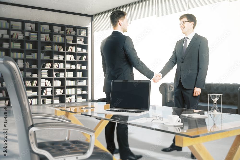 Businesspeople shaking hands in office