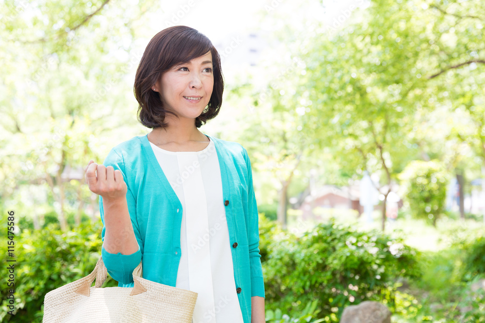 attractive asian woman walking in the park