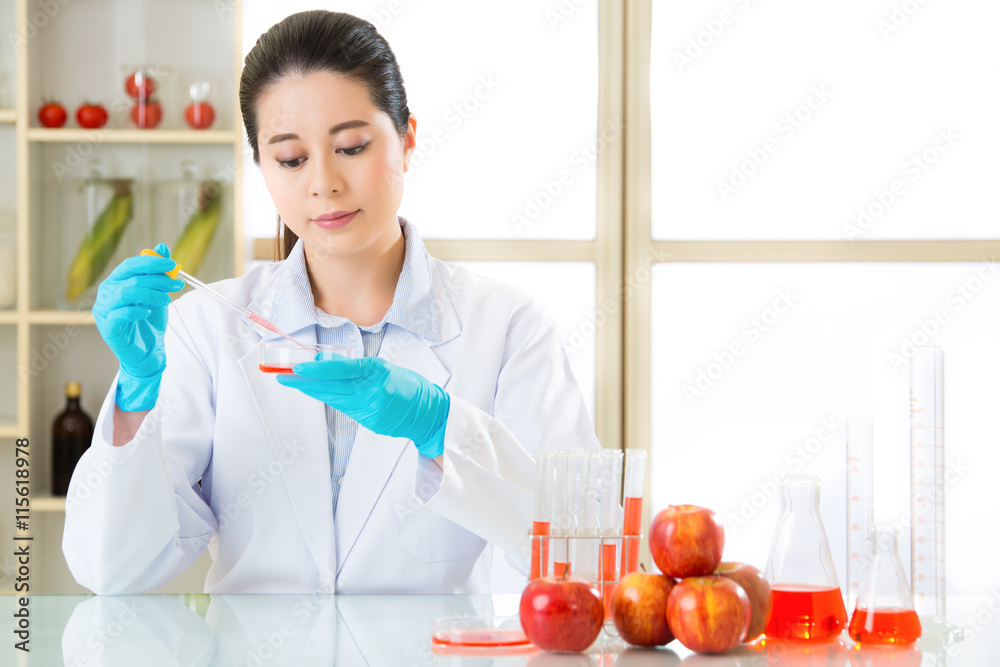 Asian female scientist examining for genetic modification food