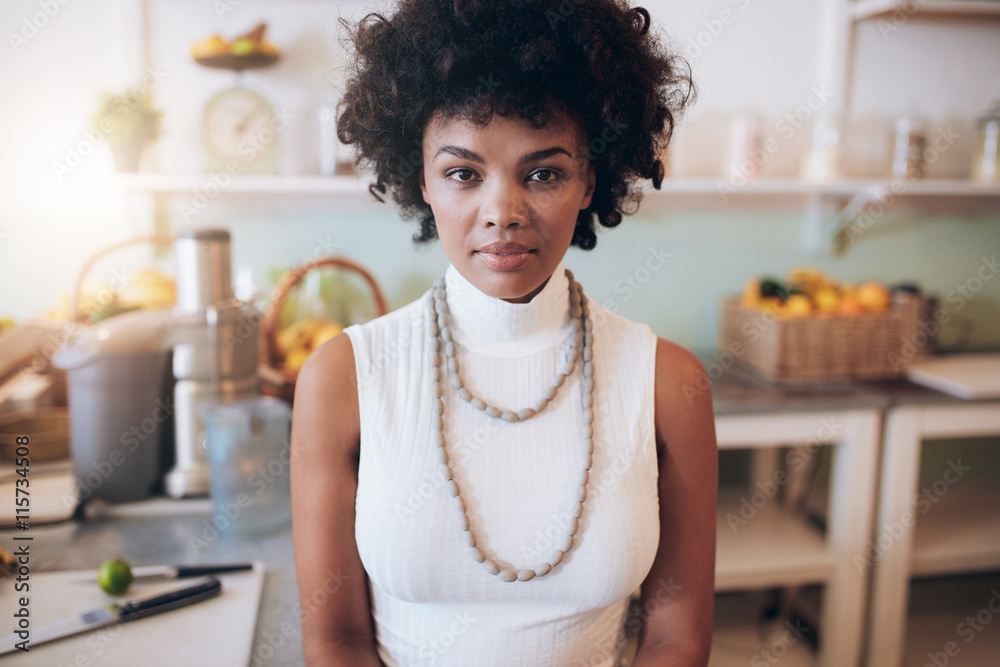 Young african woman standing at juice bar