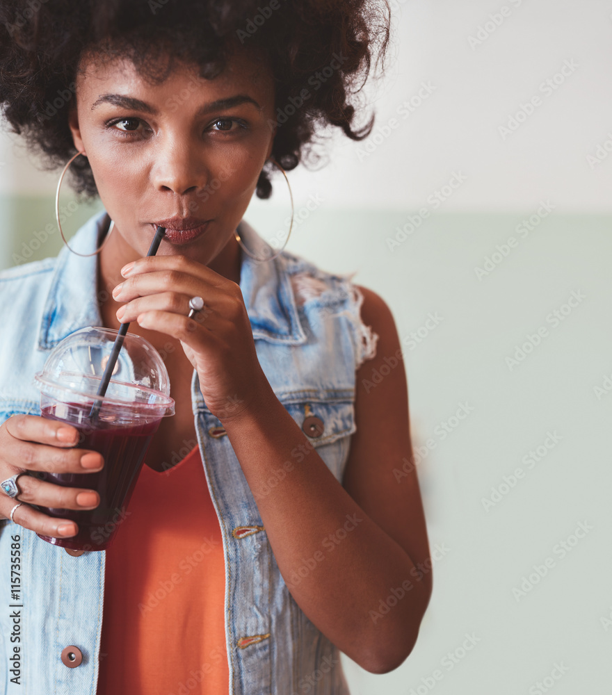 Attractive young woman drinking juice